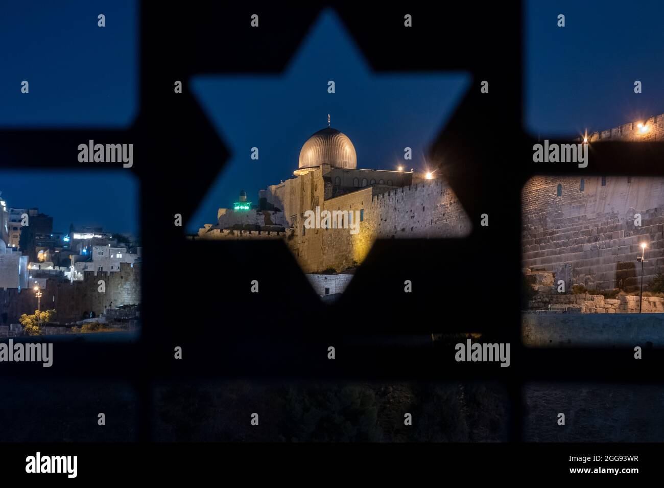 Blick auf den islamischen Schrein der Al-Aksa-Moschee über einen Zaun, der mit dem jüdischen Davidstern auf dem alten jüdischen Friedhofsberg der Oliven Ostjerusalem Israel perforiert wurde Stockfoto