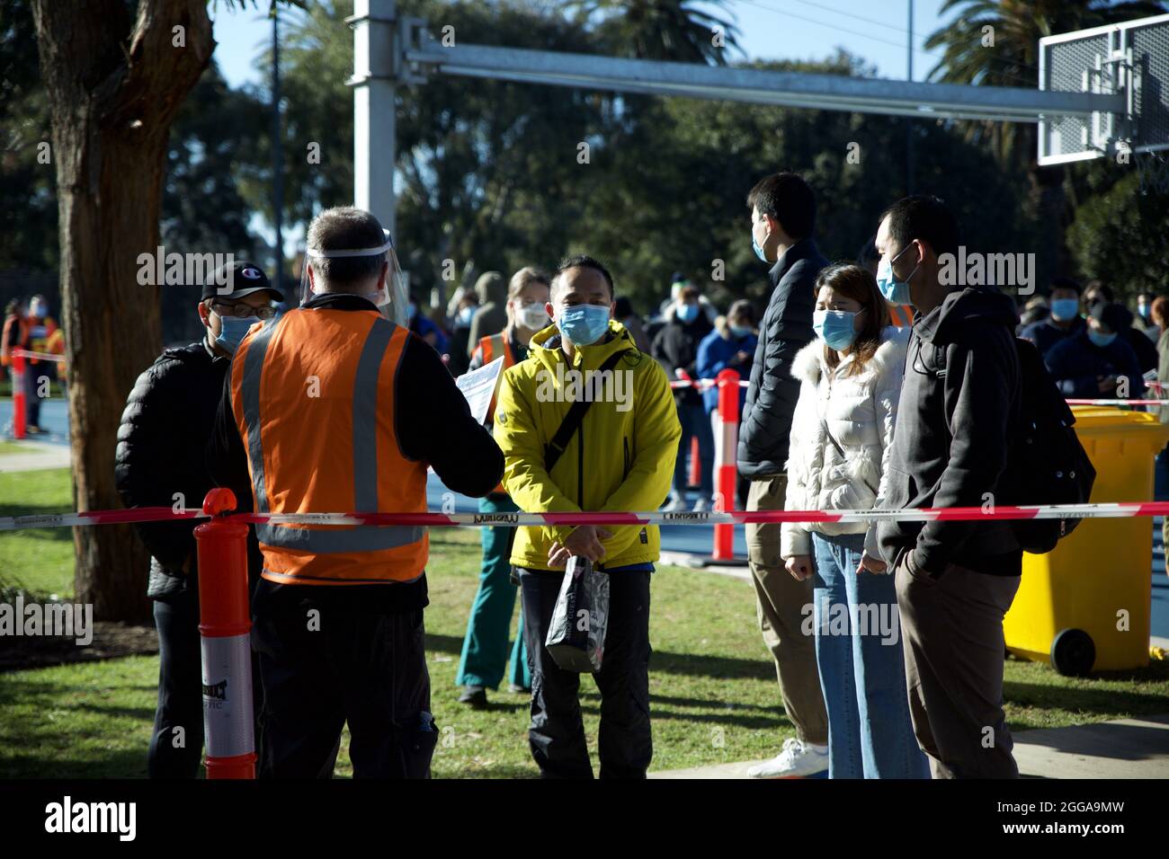 MELBOURNE, AUSTRALIEN - 28. Aug 2021: Lange Schlangen junger Menschen, die sich in der neuen Walk-in-Impfklinik Covid-19 um Coronavirus-Impfstoff anstellen Stockfoto