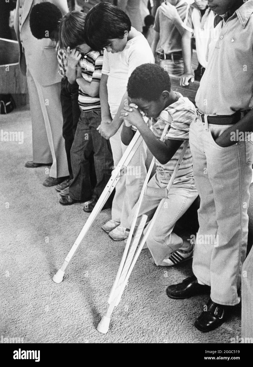 Austin Texas USA, 1984: Der schwarze Schüler Patrick Skeaton, der sein rechtes Bein aufgrund einer Spina bifida verlor, benutzt Holzkrücken, um an der Wooten Elementary School in Austin, Texas, zu kommen, während er in den regulären Unterricht integriert wird. Später wurde er mit einer Beinprothese ausgestattet. Teil einer erweiterten Fotofunktion. ©Bob Daemmrich Stockfoto
