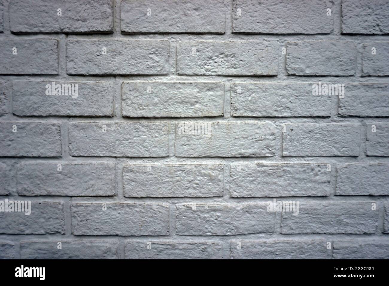 Struktur, Muster, Licht, Schatten Ziegelsteine von der Wand als Hintergrunddesign Stockfoto