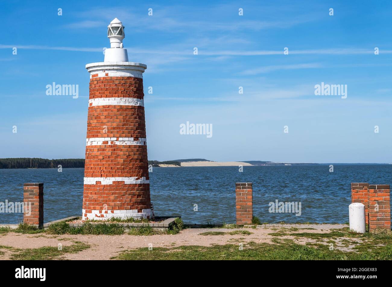 Kurische Nehrung, Kaliningrad, Russland, 10. Mai 2021. Stilisierter Leuchtturm. Navigationsfyr am Ufer. Rote und weiße Leuchtfeuer. Stockfoto