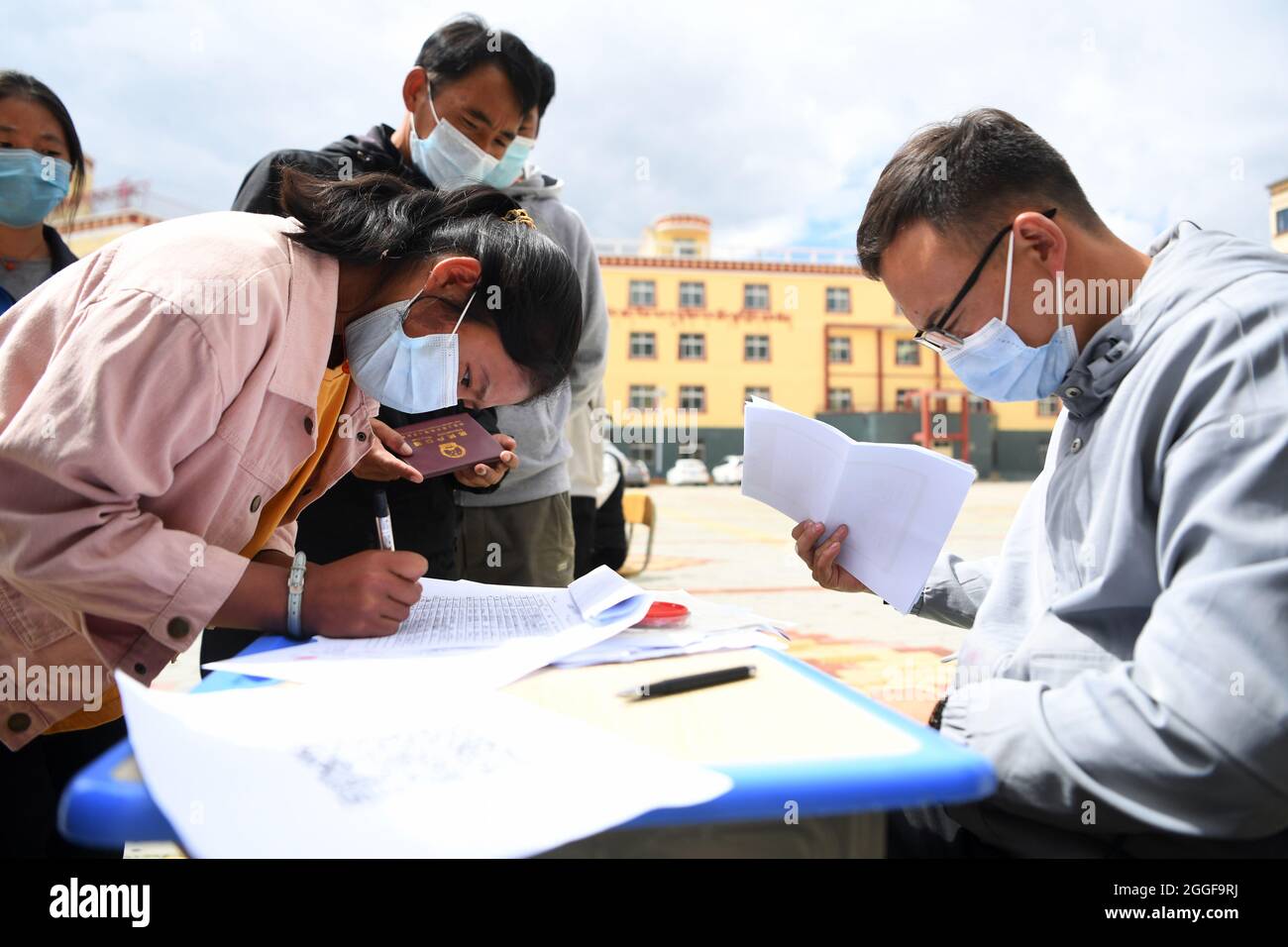 (210831) -- GANNAN, 31. August 2021 (Xinhua) -- EINE Schülerin der zehnten Klasse registriert ihre Informationen an der Luqu Tibetischen Mittelschule im Landkreis Luqu, Gannan, der autonomen tibetischen Präfektur Gannan, nordwestlich der chinesischen Provinz Gansu, am 30. August 2021. Die Tibetische Mittelschule Luqu liegt auf einer Höhe von 3,200 Metern und ist das einzige Internat im Bezirk Luqu, in dem mehr als 2,500 Schüler studieren und an der Schule leben. Die Schüler kommen überwiegend aus Grünland und Pastoralgebieten. Die Schule begrüßte am Montag ihr neues Semester mit Vorsorgemaßnahmen gegen den COVID-19. (Xinhua/Du Zheyu) Stockfoto