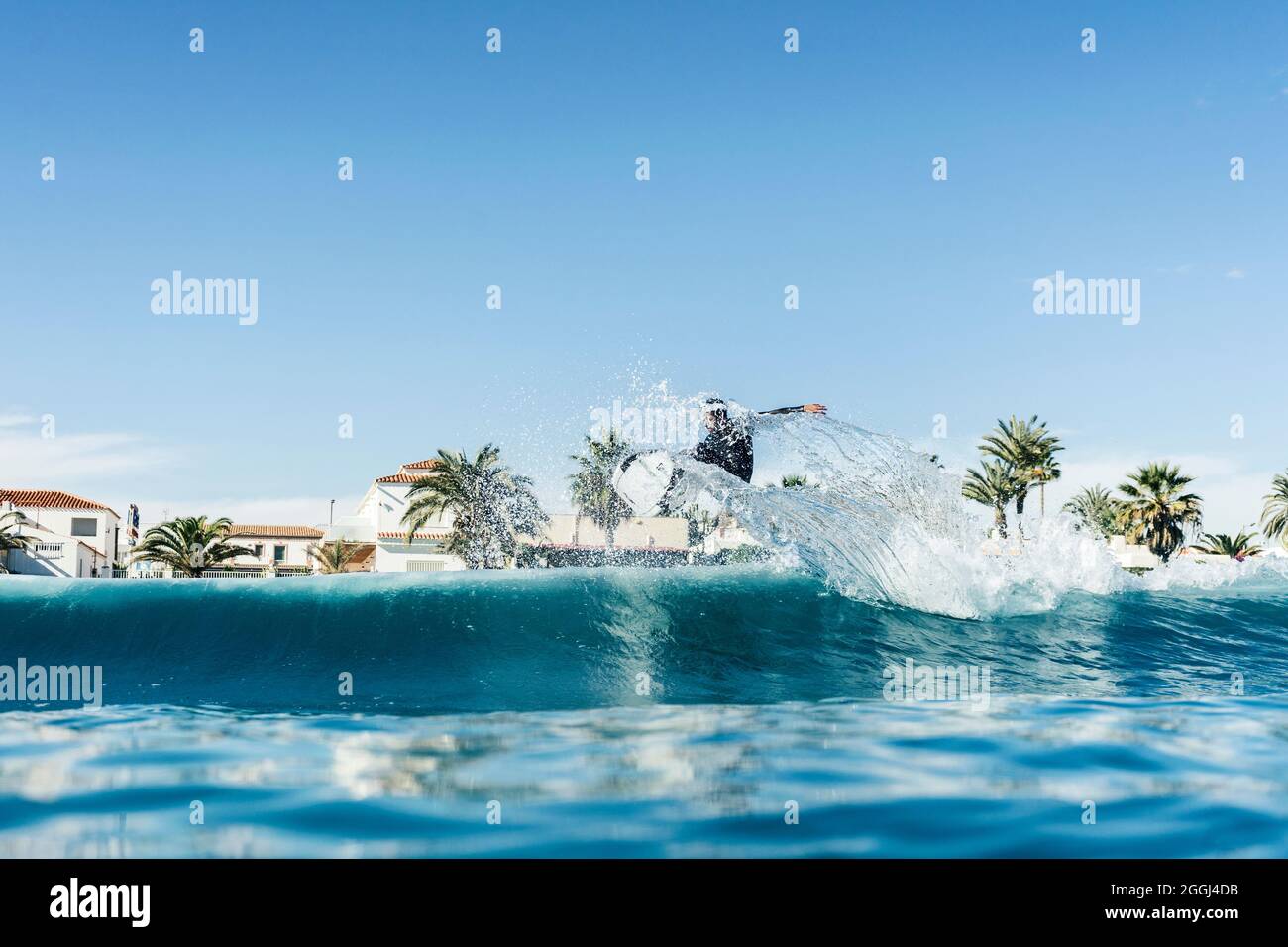 Mann surft und macht ein Surfmanöver auf einer Welle im Meer Stockfoto