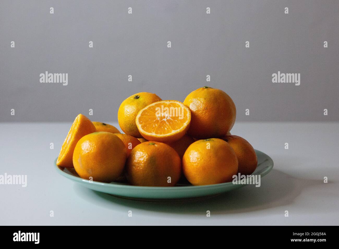 Orangen auf einem Teller grün Stockfoto
