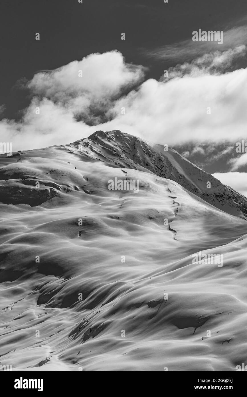 Verschneite Landschaft unter dem Gipfel des Pirchkogels in Tirol in schwarz-weiß Stockfoto