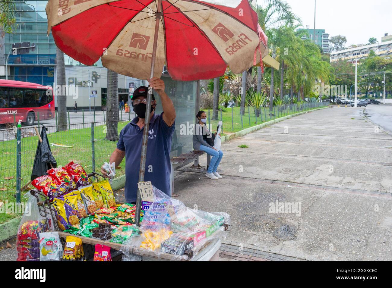 Ein Mann, der kleine Gegenstände an einer Bushaltestelle in Niteroi, Rio de Janeiro, Brasilien verkauft. Lebensstil echter Menschen. Stockfoto