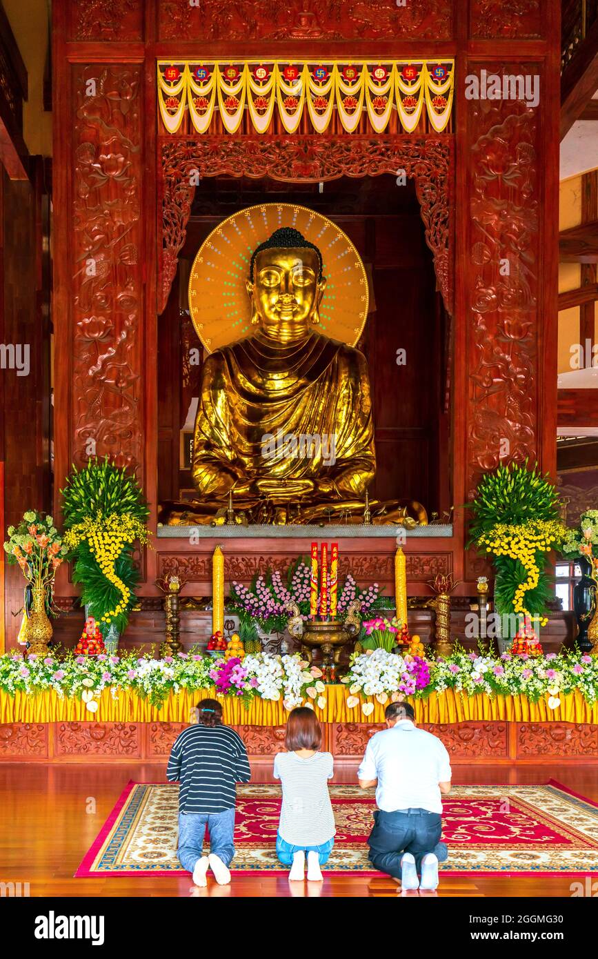 Eine buddhistische Familie betet zum Geburtstag Buddhas vor der