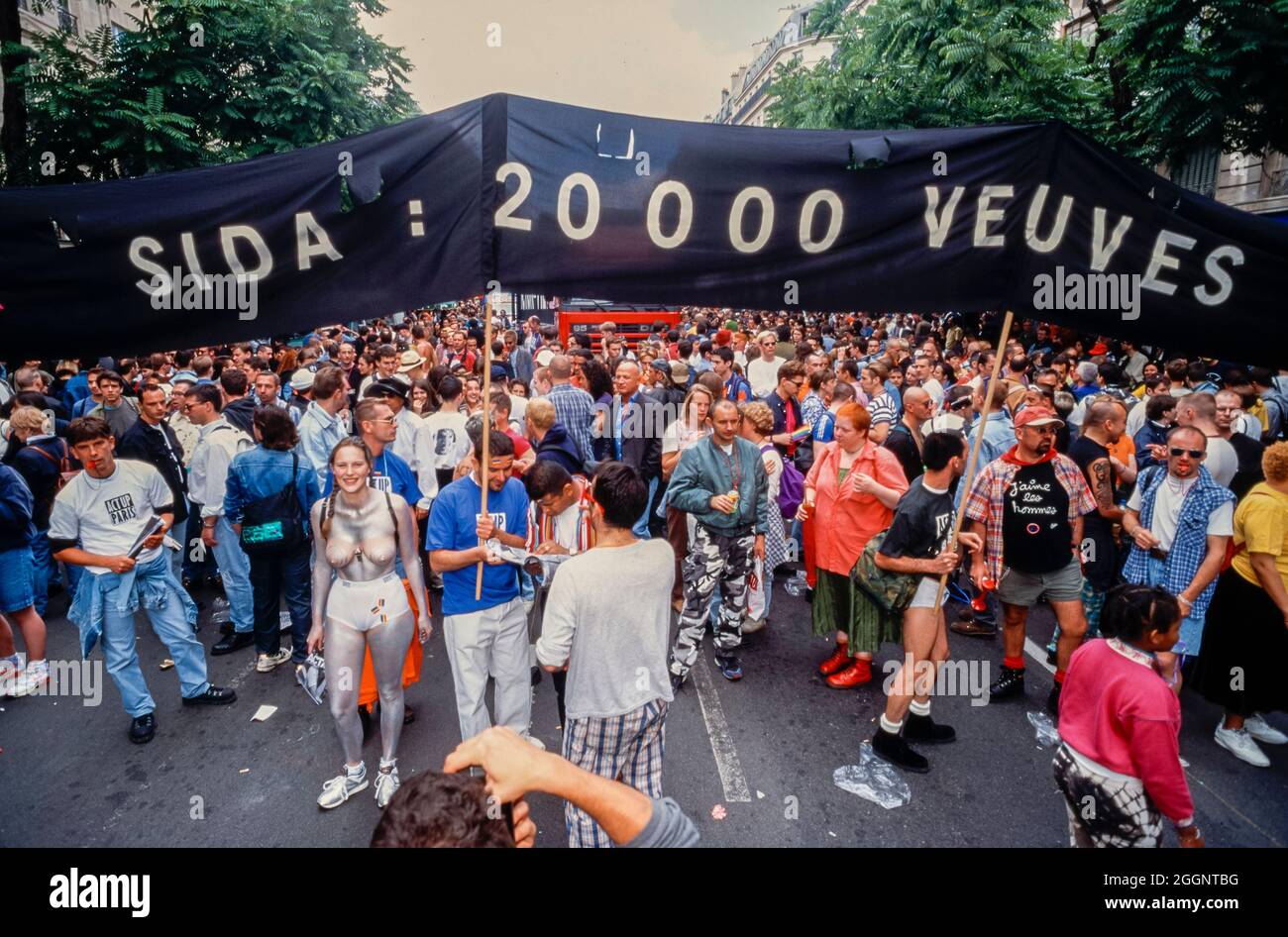 Große Menschenmenge, Front, AIDS-Aktivisten des Act Up Paris demonstrieren auf der Straße, 'Gay Pride' 1996, mit Protestbanner 'AIDS: 20.000 Witwen' junger Aktivismus Homosexuelle, schwulen Protest, Herausforderungen der öffentlichen Gesundheit Stockfoto