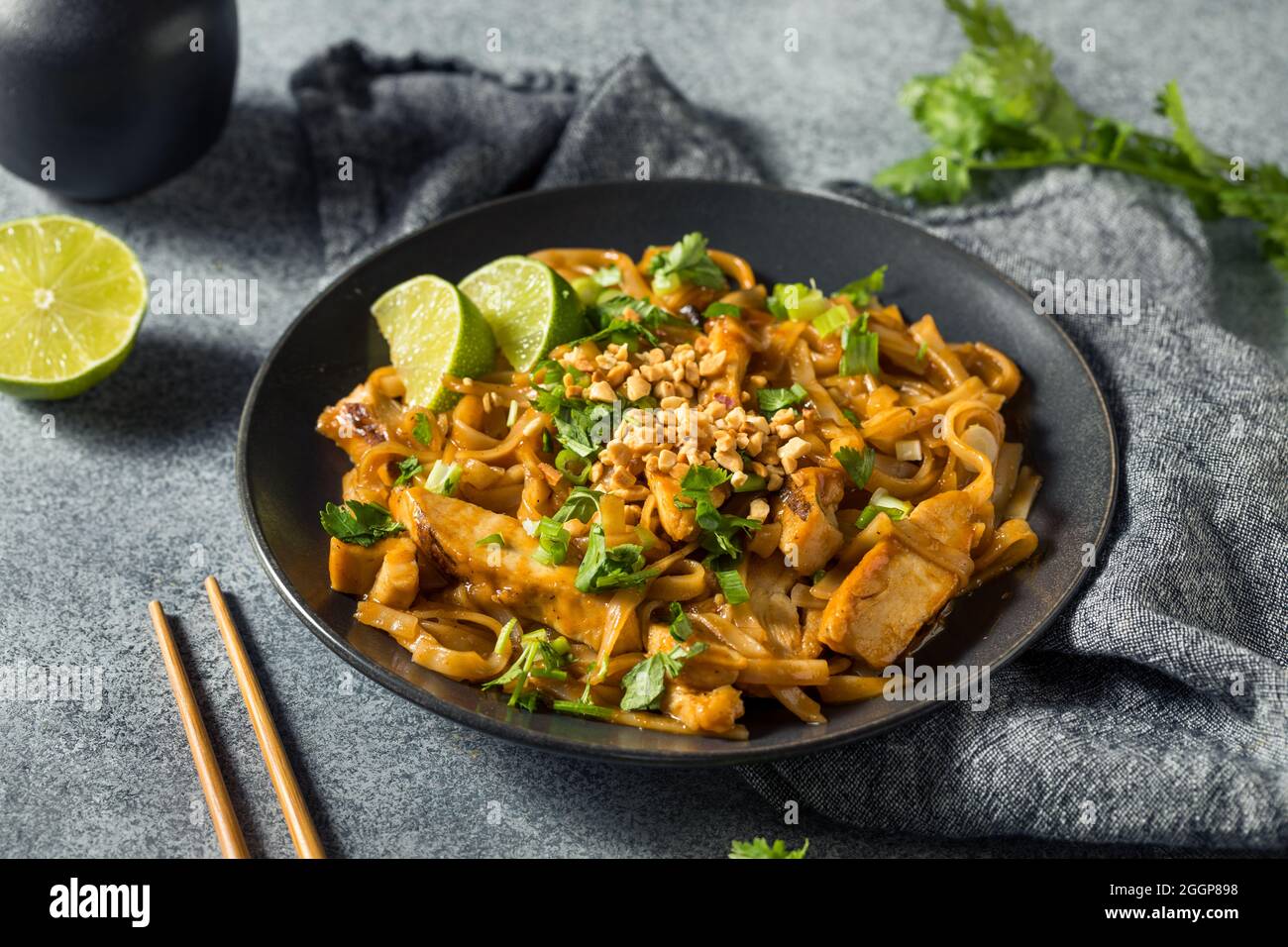 Hausgemachte asiatische Chicken Pad Thai mit Limette und Erdnüssen Stockfoto
