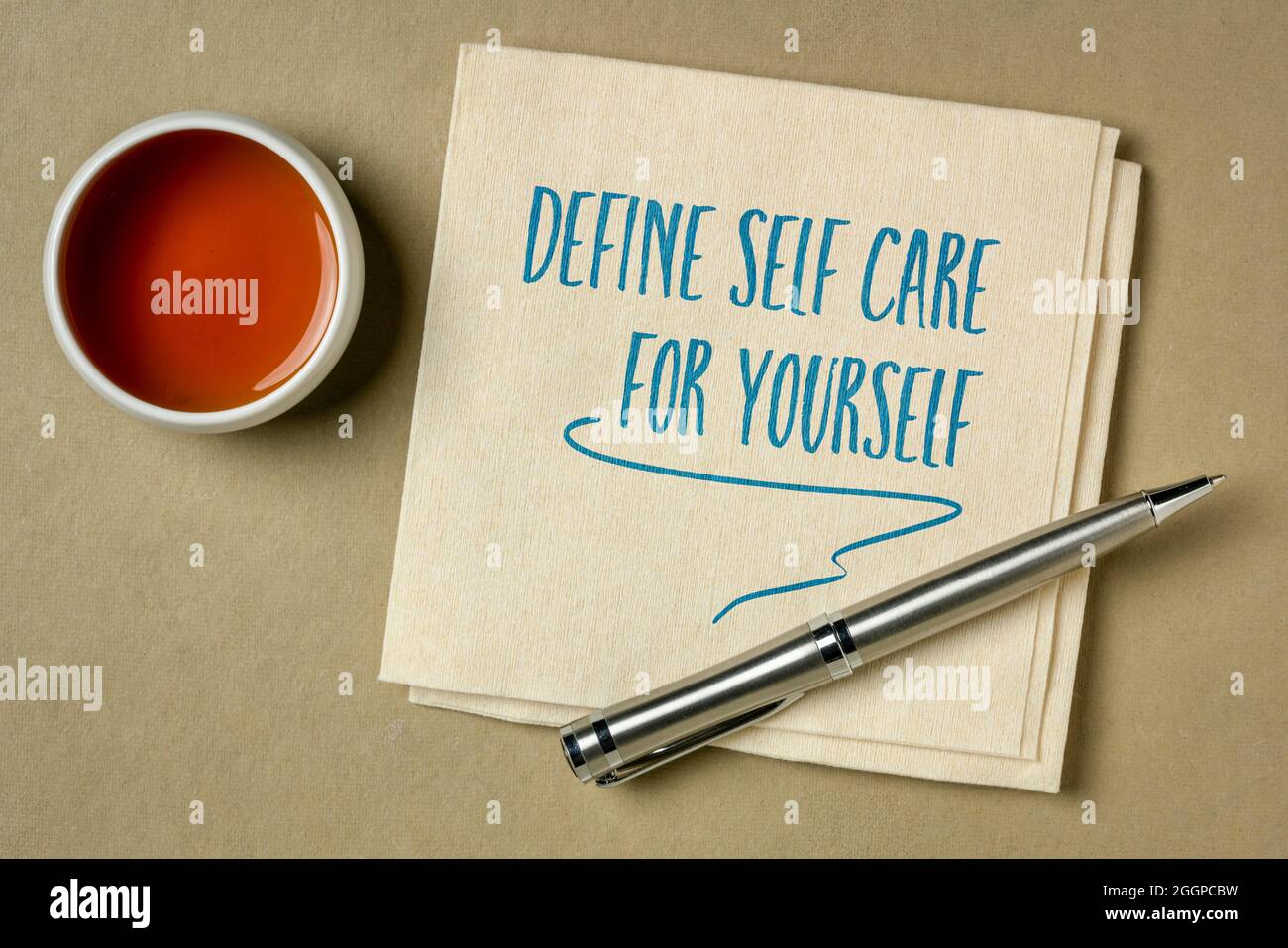 Definieren Sie Selbstpflege für sich selbst - inspirierende Erinnerung oder Ratschläge, Handschrift auf einer Serviette, Lifestyle- und Gesundheitskonzept Stockfoto