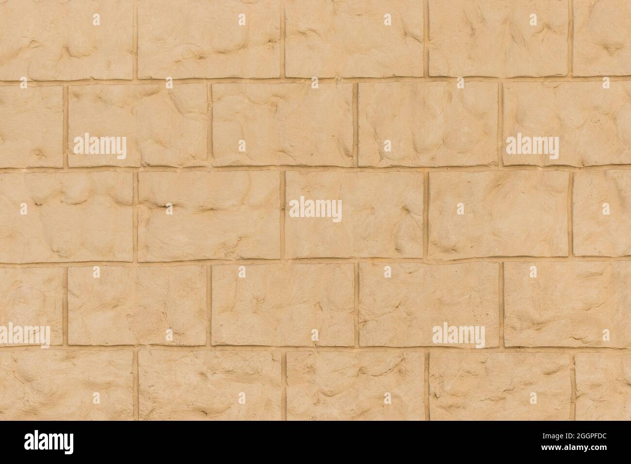 Sand Farbe Ziegel Blöcke Ton Mauerwerk Wand Textur Hintergrund. Stockfoto