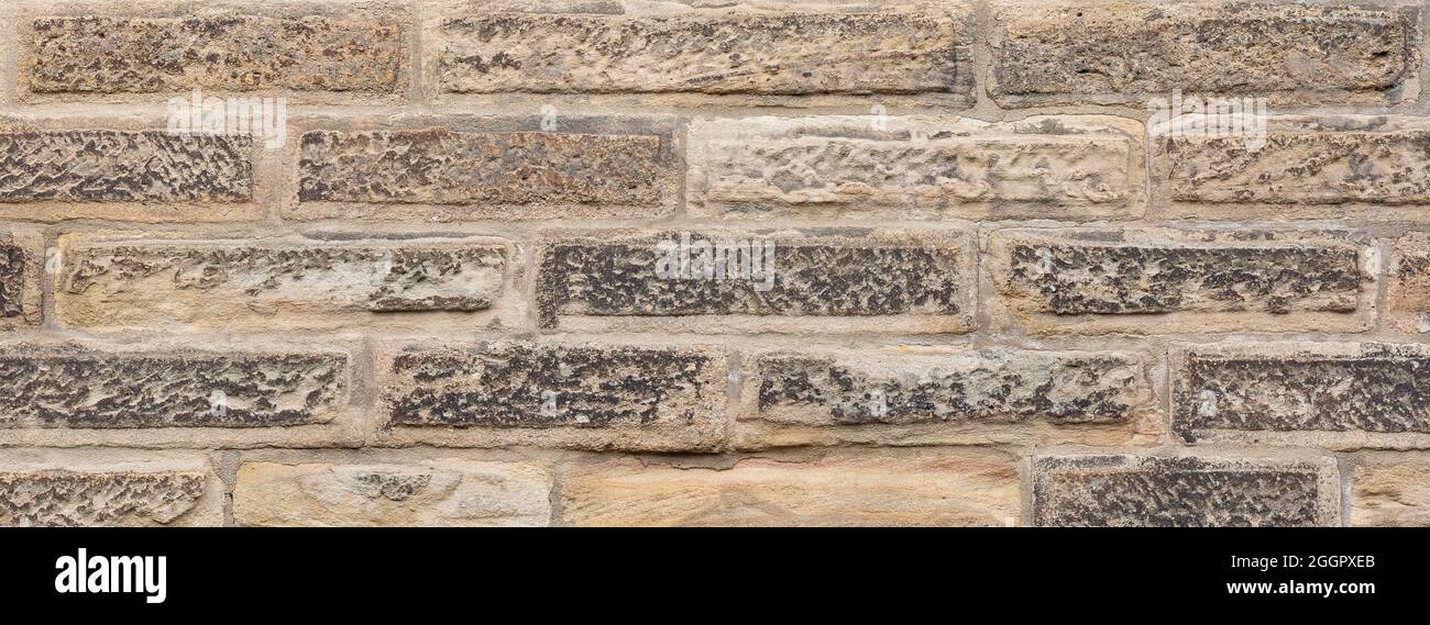 Raue sandige Textur einer alten Steinmauer Stockfoto
