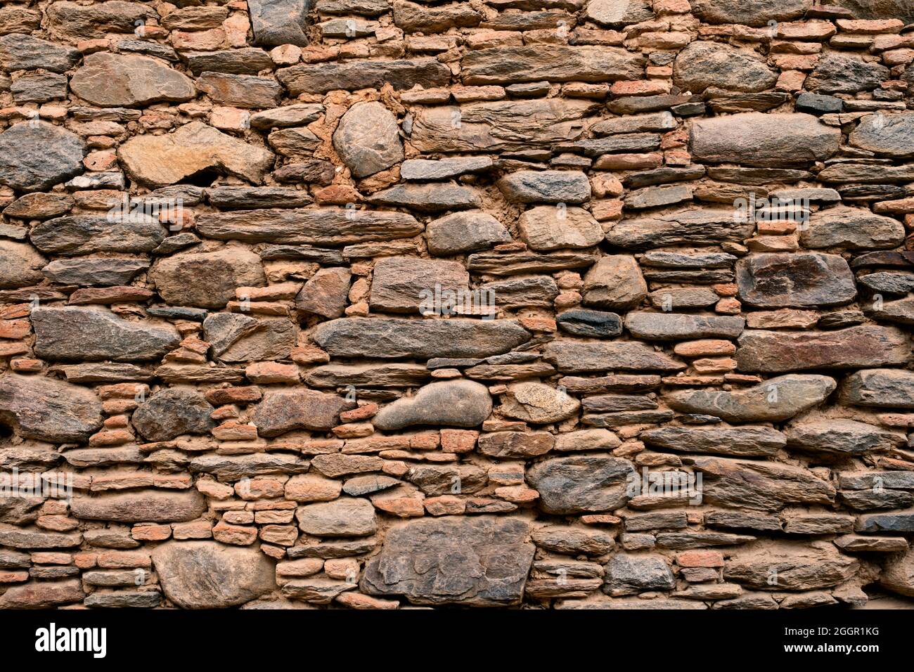 Mauer aus Natursteinen Hintergrund Stockfoto