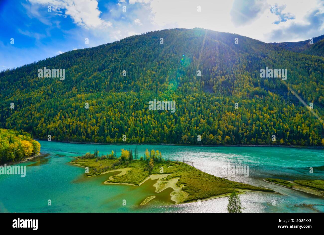 Wolong Bay of Kanas Lake. Kristallblauer Fluss, kleine Sandbank.Grüne Baumhügel. Die natürliche Schönheit des Paradieses. Kanas Nature Reserve. Xinjiang Provi Stockfoto