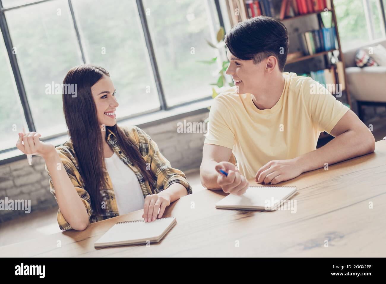 Porträt von zwei attraktiven fröhlichen Menschen Lernenden Aufgabe schriftlich Essay Hausaufgaben Prüfung in Gebäuden zu diskutieren Stockfoto