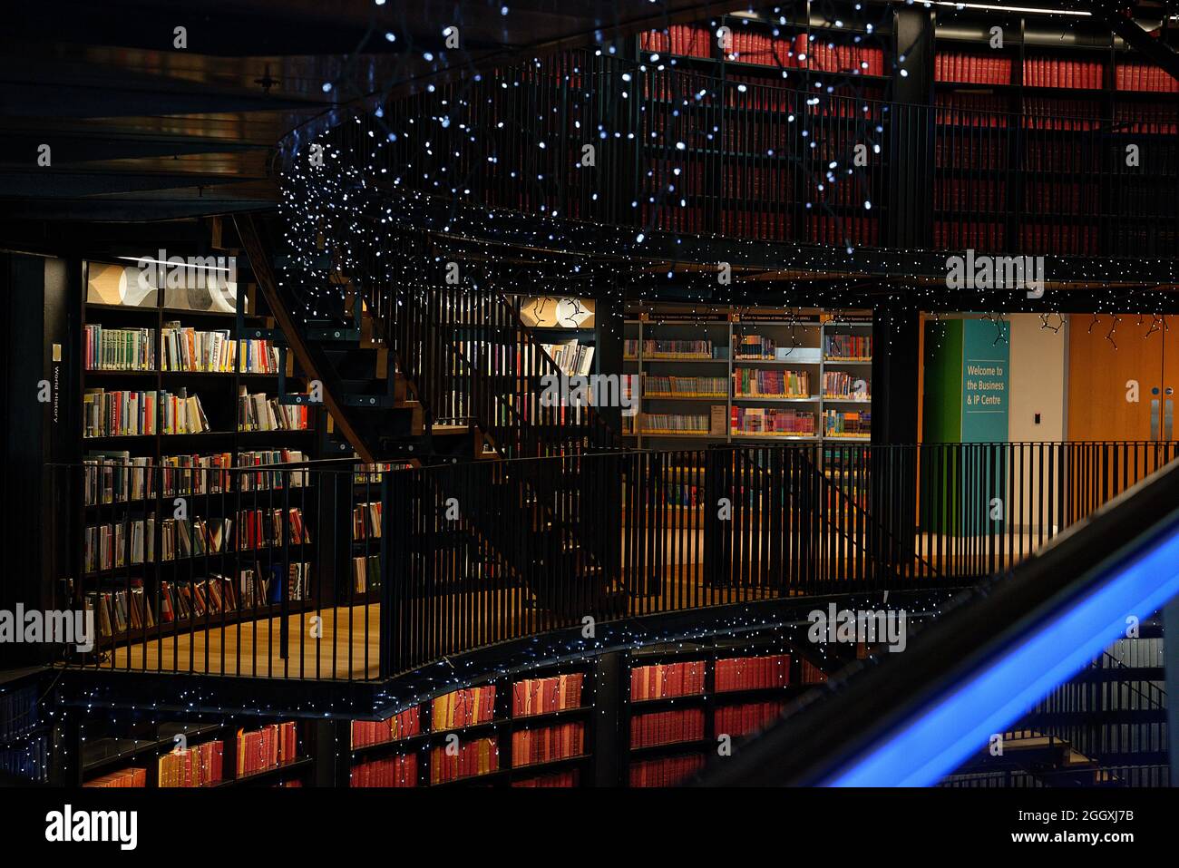 Bibliothek von Birmingham, im Zentrum der Stadt West Midlands. Gebogenes Atrium und blau beleuchtete Rolltreppen und funkelndes Licht. Stockfoto