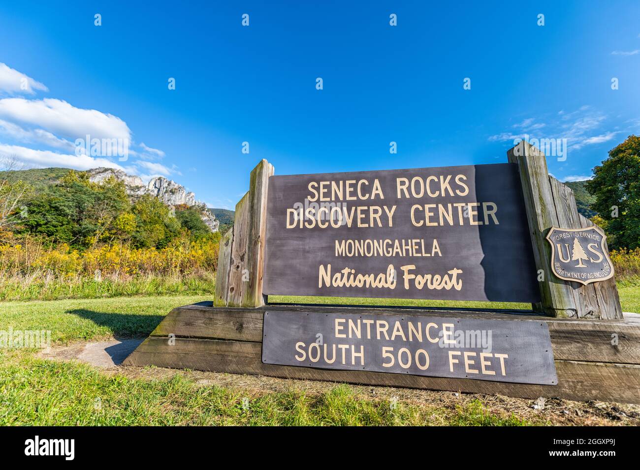 Seneca Rocks Weitwinkelansicht von Besucher Discovery Center Schild und Gebäude während der Herbstsaison und gelbe Goldrute Wildblumen Feld Wiese Stockfoto