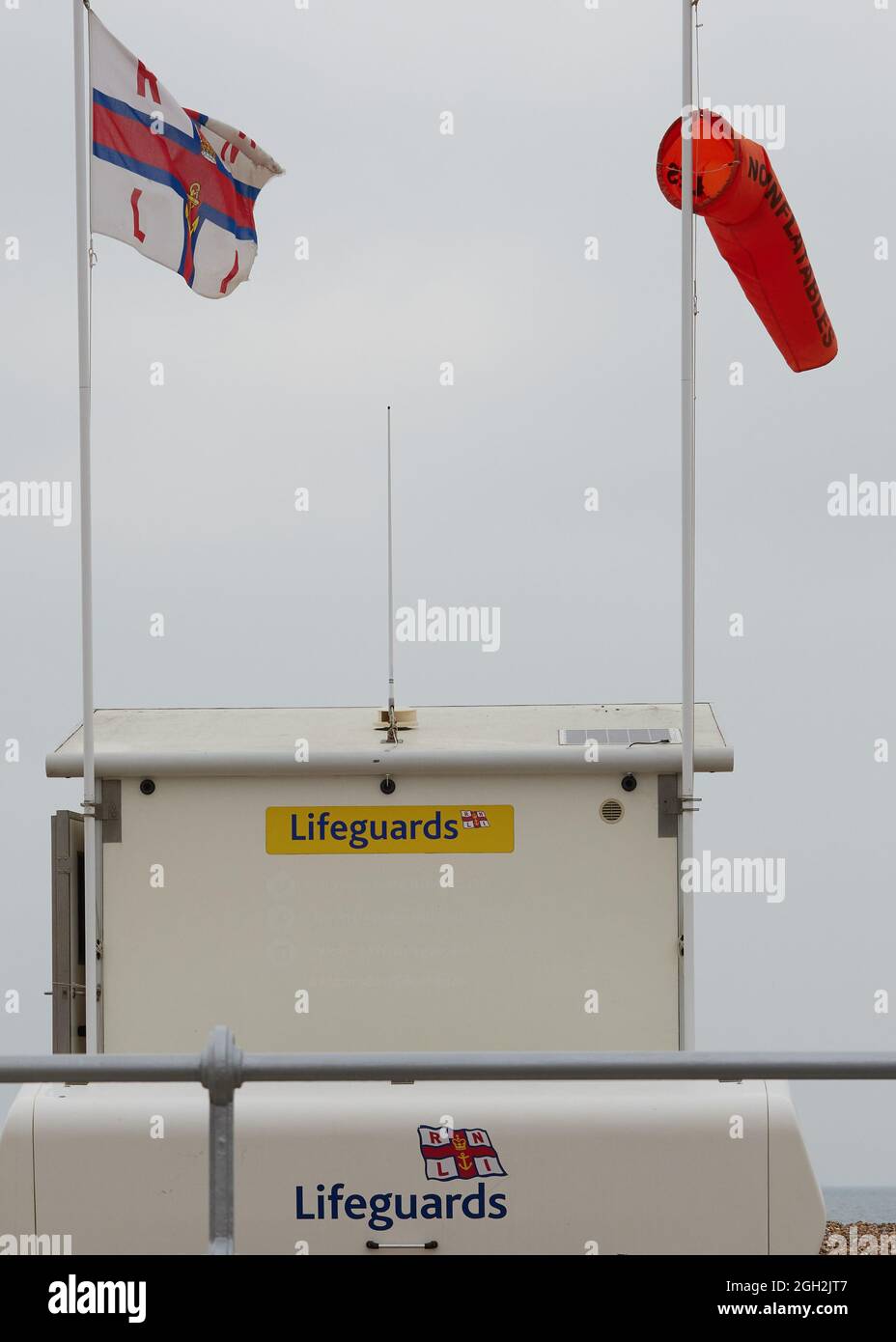 Flaggen und Logo der RNLI am Strand von Bognor Regis im Sommer 2021, Stockfoto