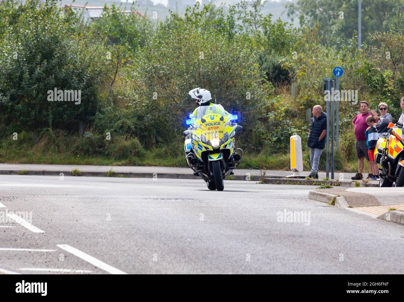 Police Motorräder, die während des Tour of Britain Cycle Race 2021 als rollende Straßensperre fungieren, als es durch Camborne in Cornwall ging. Stockfoto