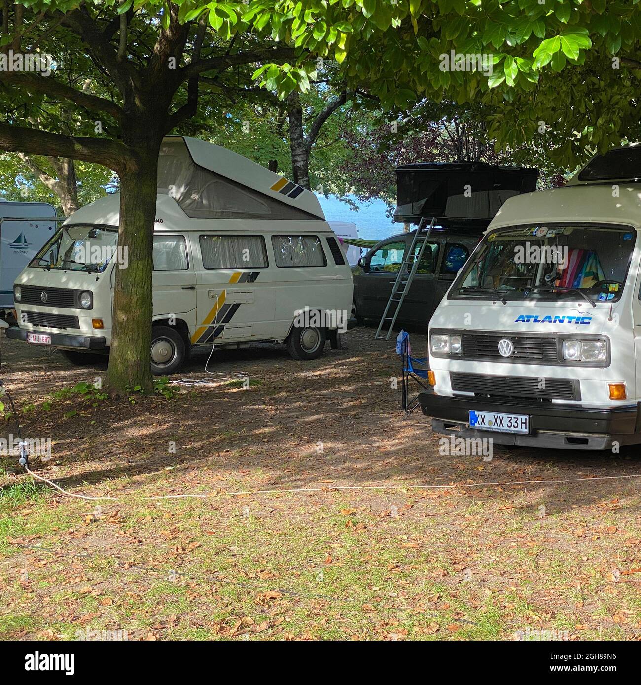 Zwei historische VW T3 Campingbusse auf einem Campingplatz am Lago di Piano in Italien. Stockfoto