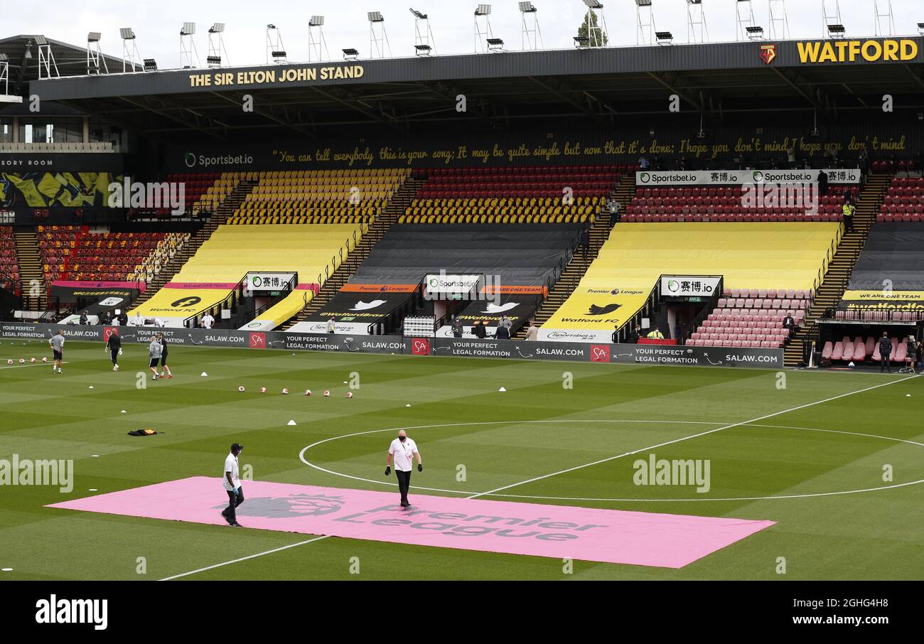 Zwei Männer in Handschuhen und Masken tragen das Premier League-Logo während des Premier League-Spiels in der Vicarage Road, Watford. Bilddatum: 20. Juni 2020. Bildnachweis sollte lauten: Darren Staples/Sportimage via PA Images Stockfoto