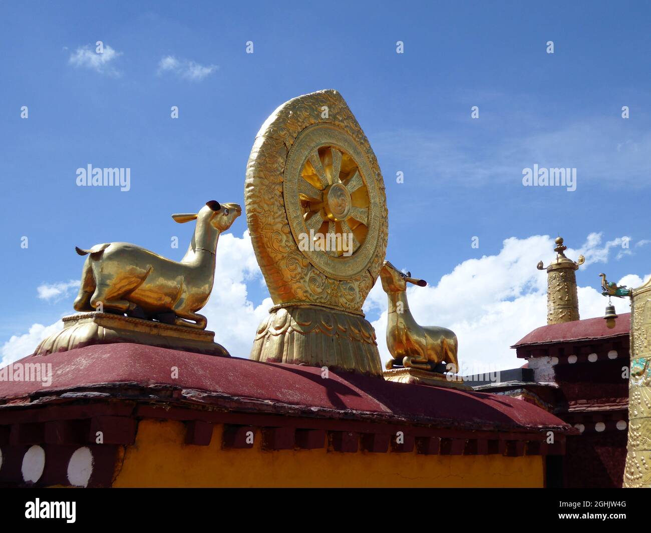 Ein Paar Hirsche flankiert das achtspeichige Dharma-Rad auf einer Lotusblume auf dem Dach des Jokhang-Klosters, Lhasa, Tibet Stockfoto