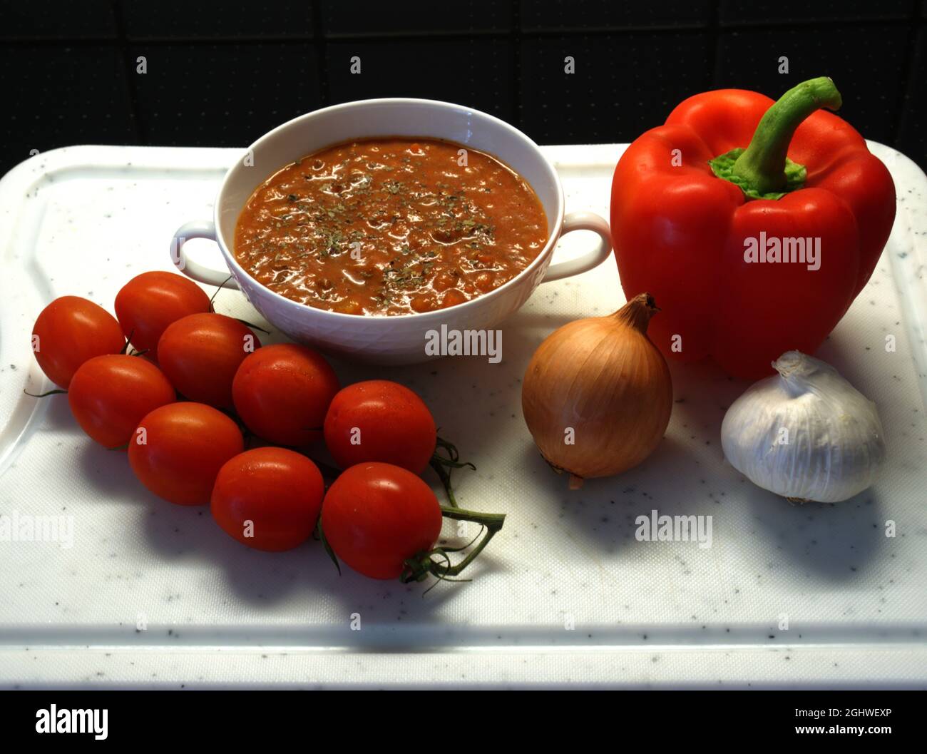 Nahaufnahme eines Brettes mit verschiedenen frischen Zutaten für eine köstliche Tomatensauce für Pasta. Stockfoto
