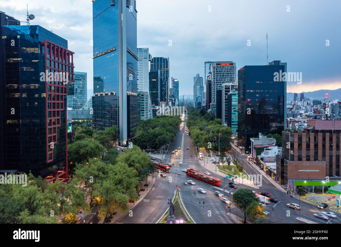 Luftaufnahme der Finanzhochhäuser mit fahrenden Bussen und Autos auf der Straße tagsüber in Mexiko-Stadt unter wolkenfreiem Himmel Stockfoto