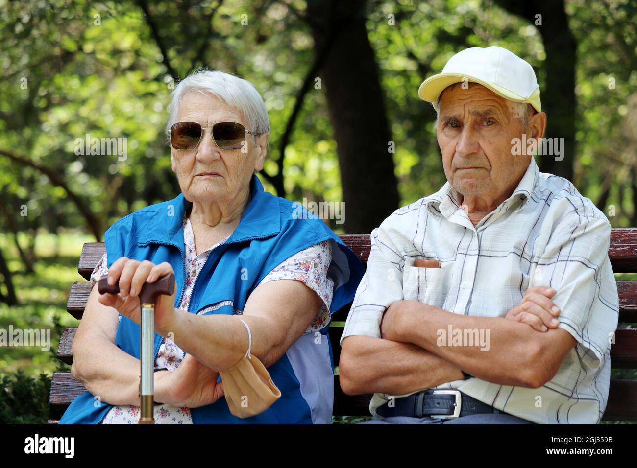 Ein älteres Paar sitzt auf einer Bank. Alter Mann und Frau zusammen, Freizeit im Park, Leben im Ruhestand Stockfoto