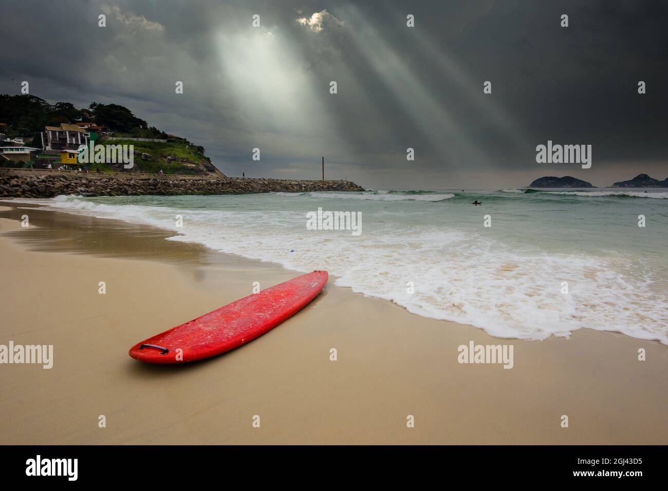 Rotes Surfbrett am Strand von Barra da Tijuca Stockfoto