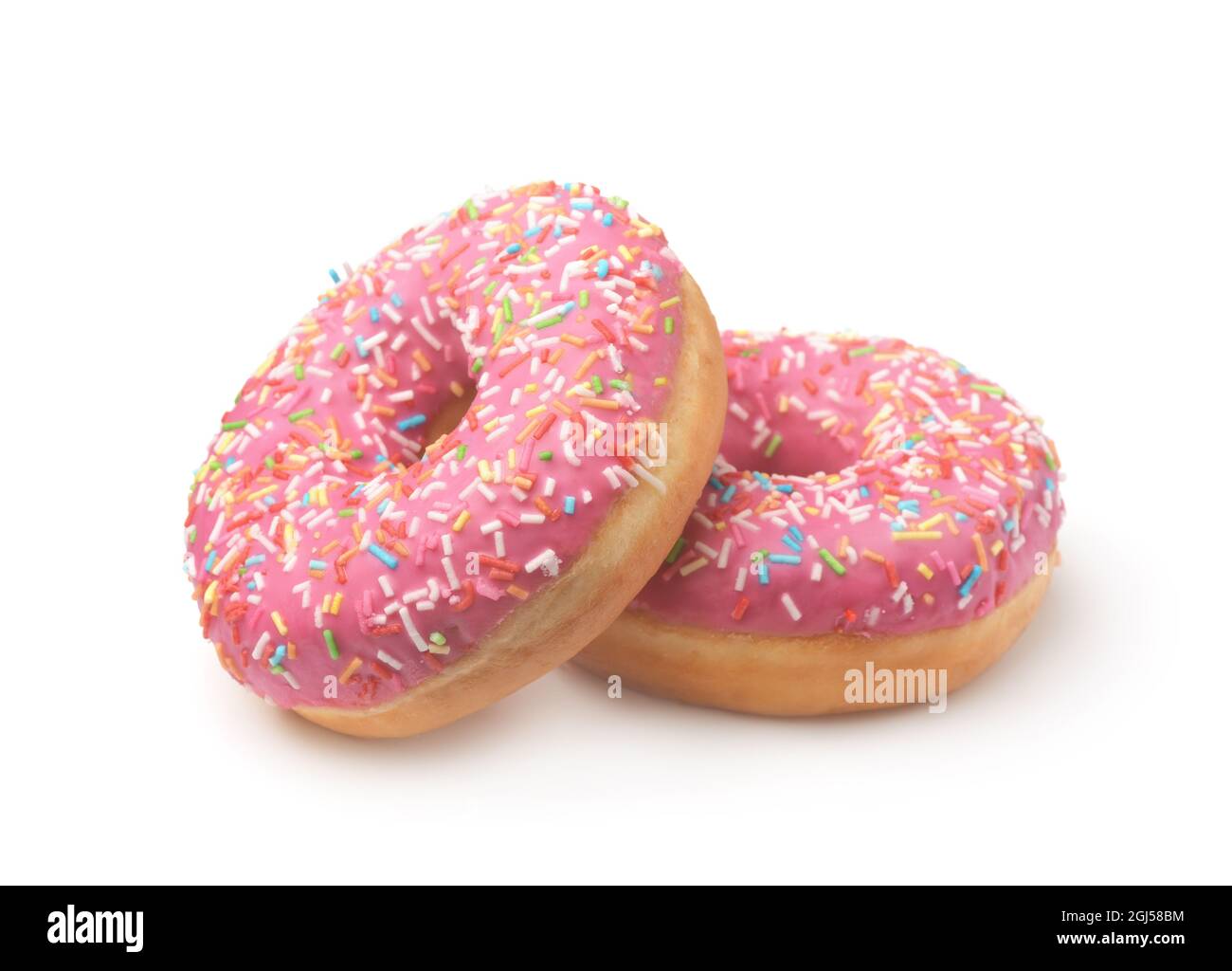 Zwei rosa glasierte Donuts mit bunten Streuseln isoliert auf einem weißen Stockfoto