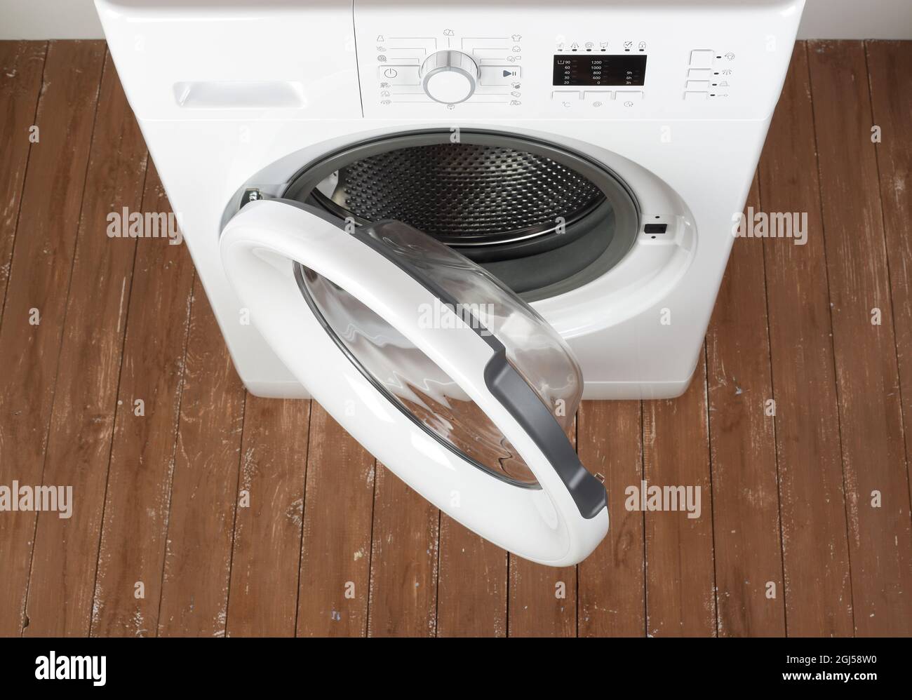 Hauptgerät - von oben geöffnete Waschmaschine auf weißem Hintergrund und Holzhintergrund Stockfoto