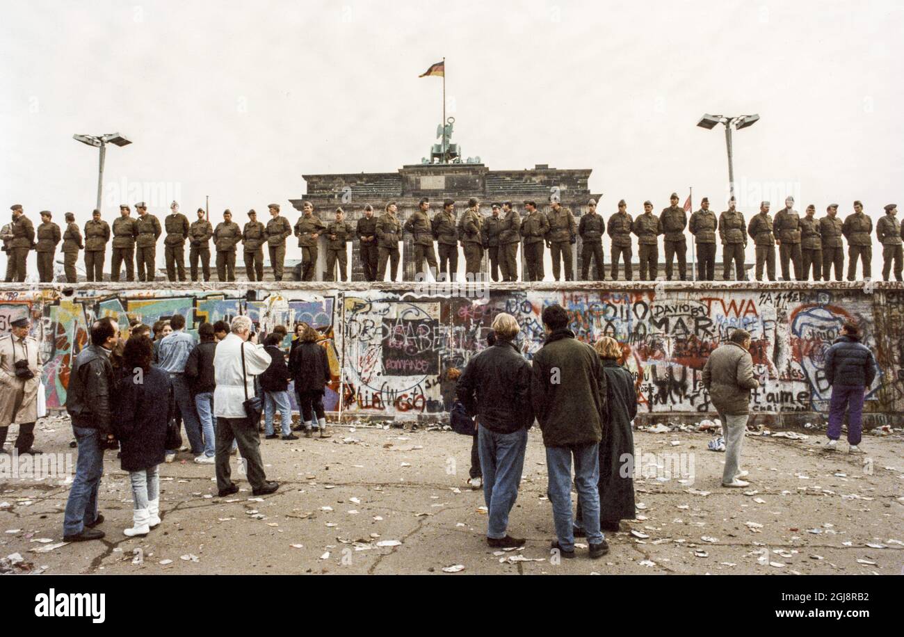 BERLIN-AKTE 1989-11-14 Eine Menschenmenge vor der Berliner Mauer nach West-Berlin, Westdeutschland, 14. November 1989, die DDR-Grenzsoldaten stehen an der Mauer vor dem Brandenburger Tor in Verbindung mit dem Mauerfall. Foto: Peter Diedrich / SVD / TT / Code: 11014 Stockfoto