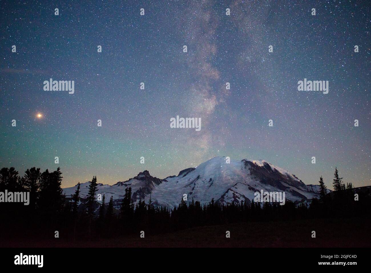 Die Lichter der Bergsteiger können auf dem Berg gesehen werden, während die Milchstraße hinter Mt. Rainier National Park, Washington State. Stockfoto