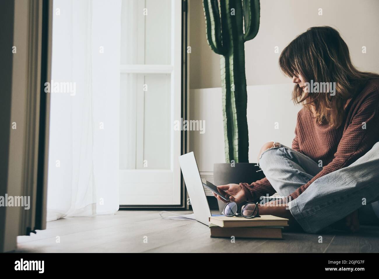 Junge Frau, die zu Hause am Laptop arbeitet. Weibliche Hände tippen auf der pc-Tastatur. Tennager, der einen Internet-Videoanruf mit entfernten Freunden führt. Mädchen, das o studiert Stockfoto