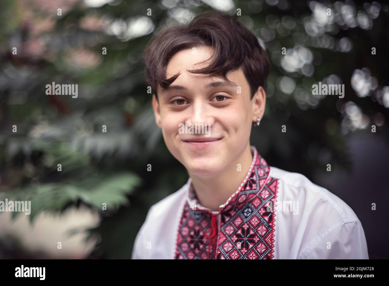 Porträt eines jungen lächelnden Teenagers in einem traditionellen ukrainischen Hemd (besticktes Hemd). Menschen in der Ukraine Stockfoto