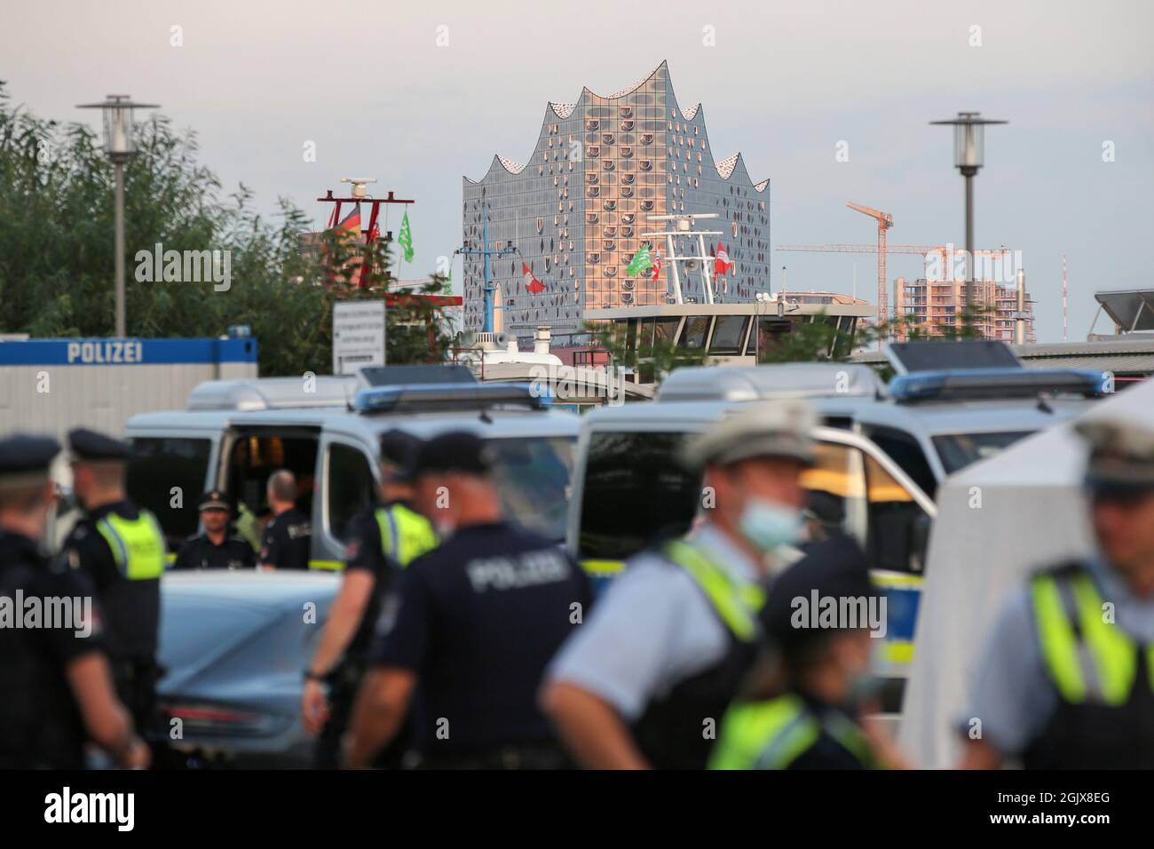 09. September 2021, Hamburg: Polizisten stehen bei einem Großscheck auf dem Hamburger Fischmarkt zusammen, im Hintergrund die Elbe-Philharmonie. Im Rahmen der 15. DIS-Woche (Drug Detection in Road Traffic) überprüfte die Hamburger Polizei mit Unterstützung spezialisierter Polizeibeamter aus zehn Bundesländern, Österreich und der Schweiz sowie mithilfe des Zolls zahlreiche Personen und Fahrzeuge. Foto: Bodo Marks/dpa/Bodo Marks Stockfoto