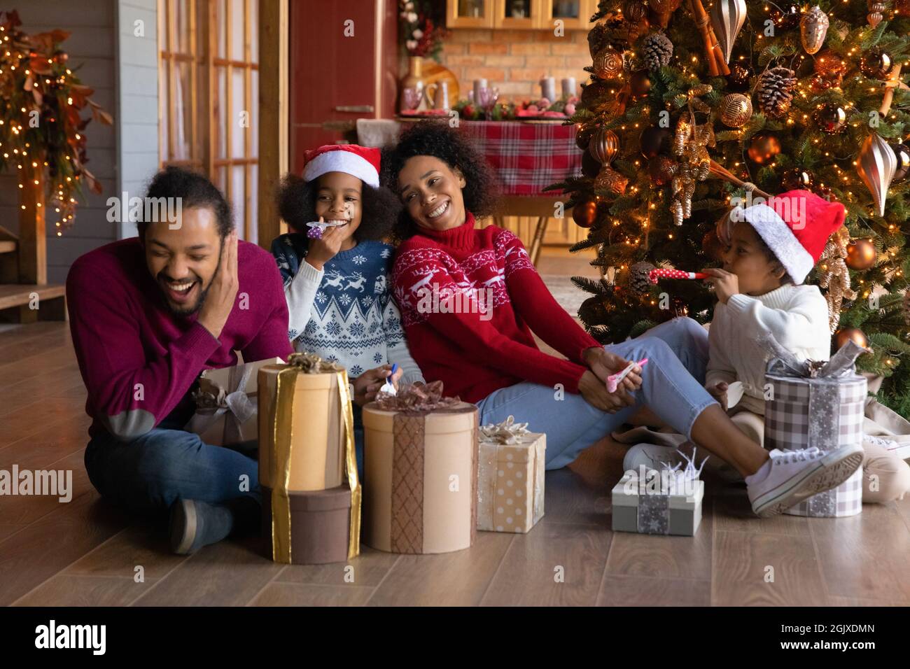 Lächelnde ethnische Familie mit Kindern Weihnachten zu Hause genießen Stockfoto