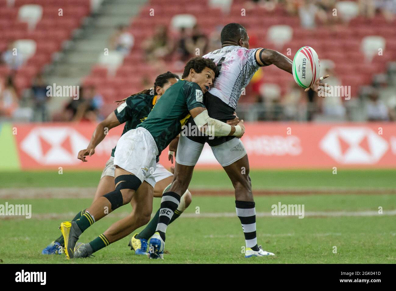 SINGAPUR-14. APRIL: Das südafrikanische 7er-Team (grün) spielt beim Cup-Finale von HSBC World Rugby Singapore Sevens am 14. April 2019 im Nationalstadion in Singapur gegen das fidschianische 7er-Team (weiß) Stockfoto