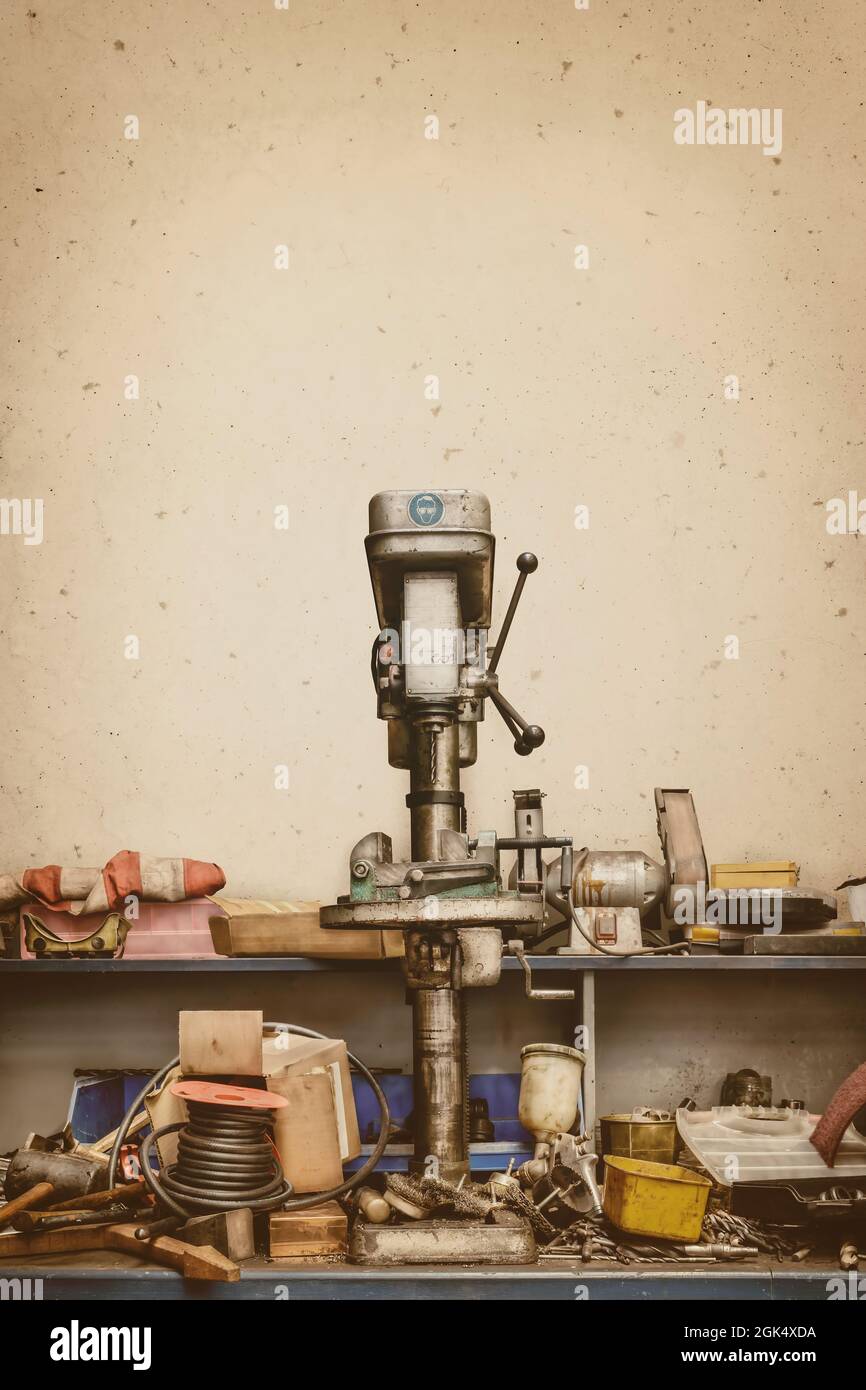 Retro-Stil Bild von einer chaotischen alten Werkstatt Bank mit Pressbohrer und Werkzeuge Stockfoto