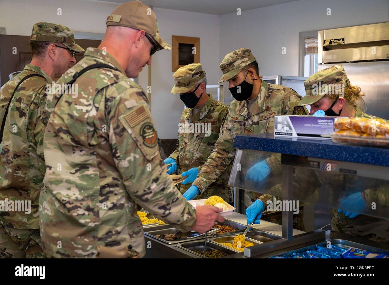 Brig. General Damon Feltman, der Mobilisierungsassistent des US-Raumfahrtkommandos des Operationsdirektors, links, Col. Shariful Khan, Kommandant des 33. Weltraumflügels, Mittelmann und Obermeister. Sgt. Stephanie Moncieri, Kommandochefin der 33. SW, serviert den Mitgliedern der 710. Sicherheitskräfte während der monatlichen Unit Training Assembly des Flügels an der US Air Force Academy in Colorado Springs, Colorado, am 7. August 2021 ein Abendessen. Stockfoto