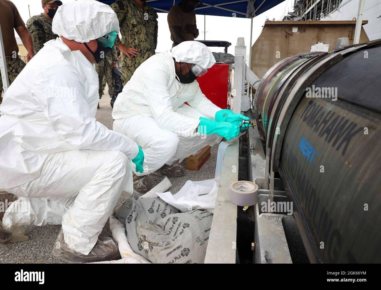 POLARIS POINT, Guam (12. August 2021) Torpedomans Mate 1st Class Michael Cloran, Left, und Torpedomans Mate 2nd Class Darnell Bennett, beide dem U-Boot-Tender USS Emory S. Land (AS 39) zugeordnet, simulieren die Reinigung eines Treibstoffauslaufes während einer Tomahawk Land Attack Missile (TLAM) Rezertifizierung, August 12. Land schließt die TLAM-Rezertifizierung ab, um Aufgaben als leitende Wartungsaktivitäten in Guam zu übernehmen, wo das Schiff in der Lage sein wird, Waffen zu laden und auf U-Boote und Kämpfer an der Oberfläche zu laden, während es im Vorwärtseinsatz ist. Stockfoto