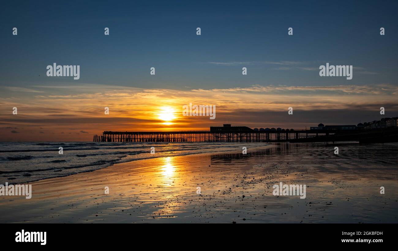 Hastings Pier & Strand bei Sonnenuntergang Stockfoto