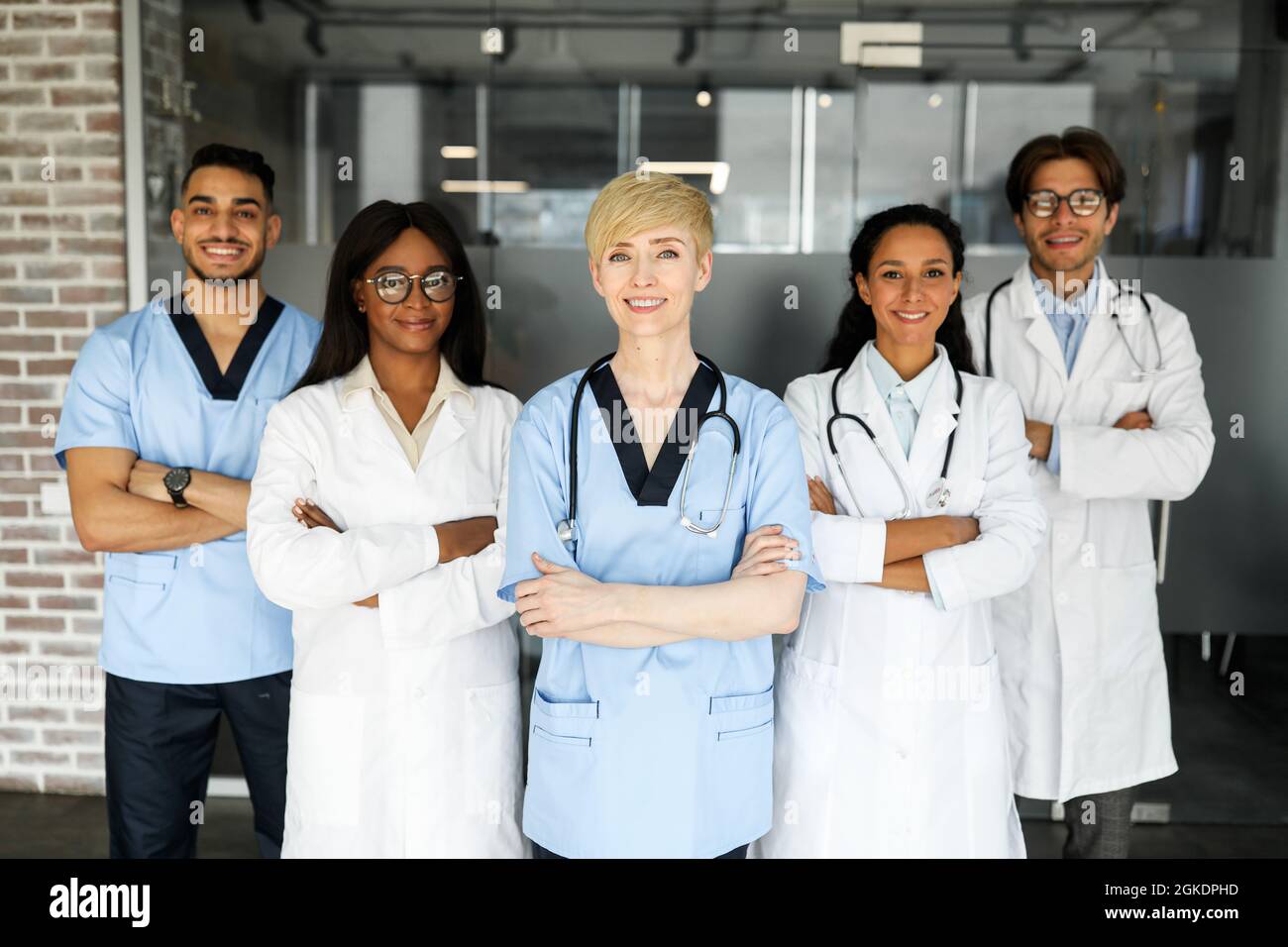 Freundliches multirassisches Ärzteteam, das im Krankenhaus posiert Stockfoto
