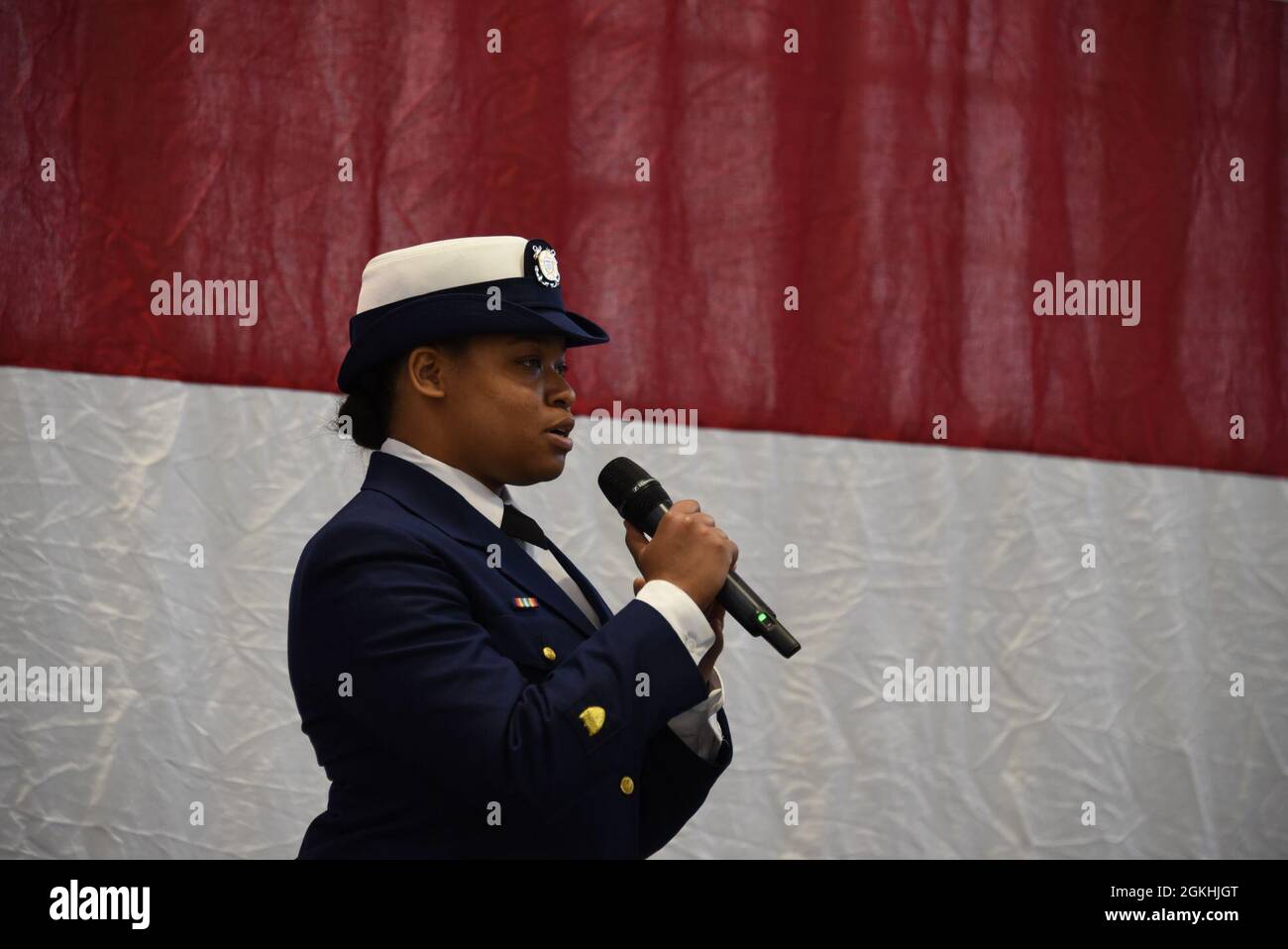 Petty Officer 3rd Class Elizabeth Covington singt am 24. April 2021 die Nationalhymne für die Stilllegung durch den Küstenwachtschneider Douglas Munro (WHEC724) in Kodiak, Alaska. Der Kodiak-basierte Schneider ist der letzte der 378-Fuß-Hochleistungsschneider, der der Küstenwache diente, indem er nationale und internationale Missionen 49 Jahre lang durchführte. Stockfoto