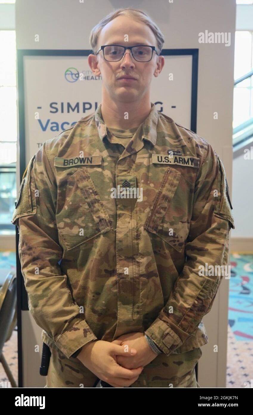 US Army Staff Sgt. Lucas Brown, der Bravo Company, dem 2. Bataillon und der 2. Sicherheitskräfte-Assistenzbrigade zugeordnet ist, spricht über seine Erfahrungen während der Impfbemühungen im Community Impfzentrum im Wisconsin Center in Milwaukee, 5. Mai 2021. Brown ist in einer allgemeinen Funktion tätig und hat vor Ort sehr gute Erfahrungen mit Kunden gemacht. „Es hilft mir wirklich, meine Kommunikationsfähigkeiten auszuarbeiten; man kann mit Menschen sprechen“, sagt er. „Wir versuchen, uns mit ihnen zu setzen, nehmen uns einfach die Zeit, wie ein 15-minütiges Gespräch mit ihnen zu führen, und lernen einfach ein wenig über uns kennen Stockfoto