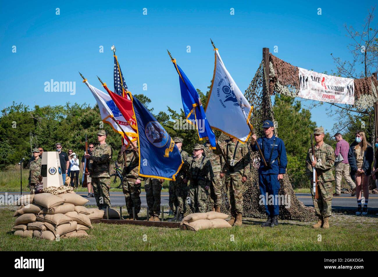 210515-N-WF272-1104 LEWES, Del. (15. Mai 2021) Dienstmitglieder, die Nationalgarde, Armee, Marine, Küstenwache und Luftwaffe vertreten, präsentieren die Farben, um den Start eines Race4Warriors Challenge-Laufs im Cape Henloopen State Park, Delaware, zu kennzeichnen. Der 5-km-, 10-km- und 13.1-Lauf wurde von der gemeinnützigen Organisation Race4Warriors, Inc. Organisiert, deren Mission es ist, Veteranen zu ehren, die im Nahen Osten gedient haben, und verwundete Krieger und obdachlose Veteranen zu unterstützen, während sie lokale Gemeinschaften ausbilden und ihre Verbindungen zu den Veteranen stärken. Stockfoto