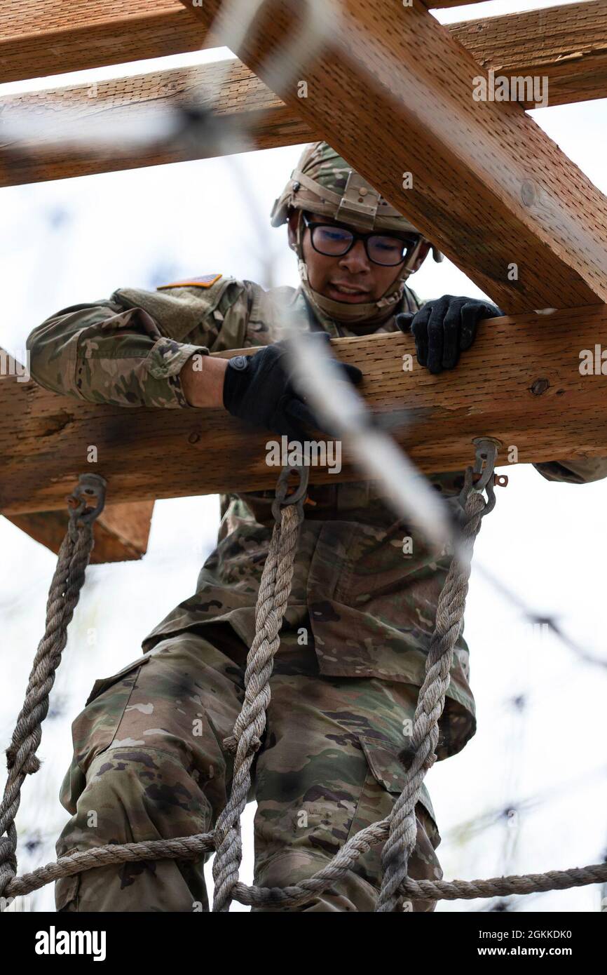 Alaska Army National Guardsman Spc. Jysamon Sanouvong, ein militärischer Polizist, der der 49. Interceptor Security Company auf dem Militärgelände zugewiesen wurde, klettert im Rahmen des Alaska Army National Guard Best Warrior Competition am 15. Mai 2021 auf einem Hindernisparcours über eine Säule auf dem Joint Base Elmendorf-Richardson. Der Wettbewerb „Beste Krieger“ würdigt Soldaten, die sich für die Werte der Armee einsetzen und das Kriegerethos verkörpern. Stockfoto