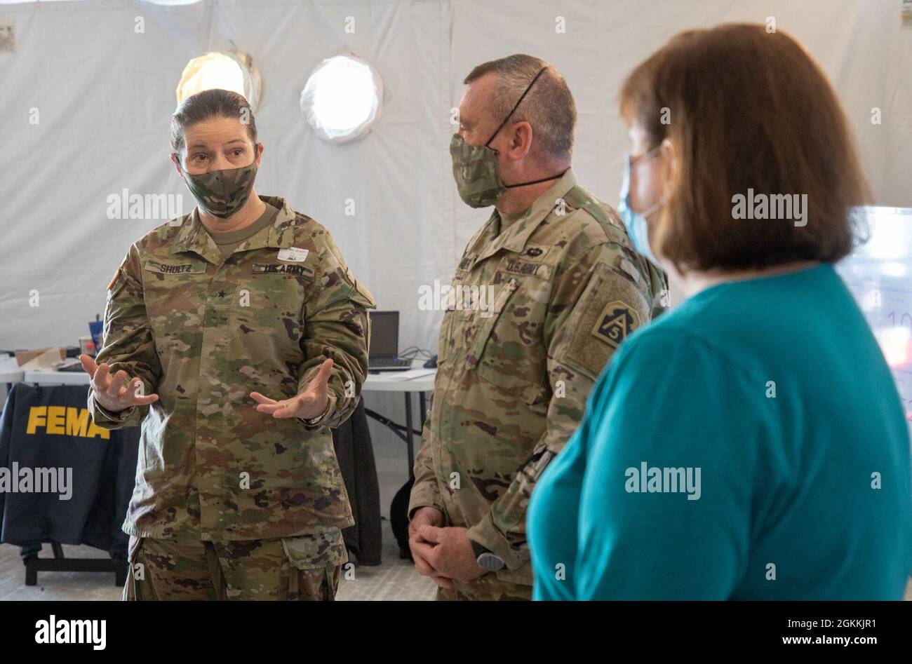 US Army Brig. General Dustin A. Shultz, links, Kommandeur der Reserve der Armee, spricht mit Oberst Ricky Shawyer, Mitte, einem Verbindungsoffizier der US-Armee Nord und Vanessa Winans, rechts, Ein Experte für öffentliche Angelegenheiten bei der Federal Emergency Management Agency über die laufenden Impfbemühungen im staatlich geführten Pilotprojekt-Impfzentrum der Gemeinschaft an der Greenbelt Metro Station in Greenbelt, Maryland, 18. Mai 2021. Das U.S. Northern Command setzt sich über die U.S. Army North weiterhin dafür ein, dem Federal EM weiterhin flexible Unterstützung durch das Verteidigungsministerium zu leisten Stockfoto