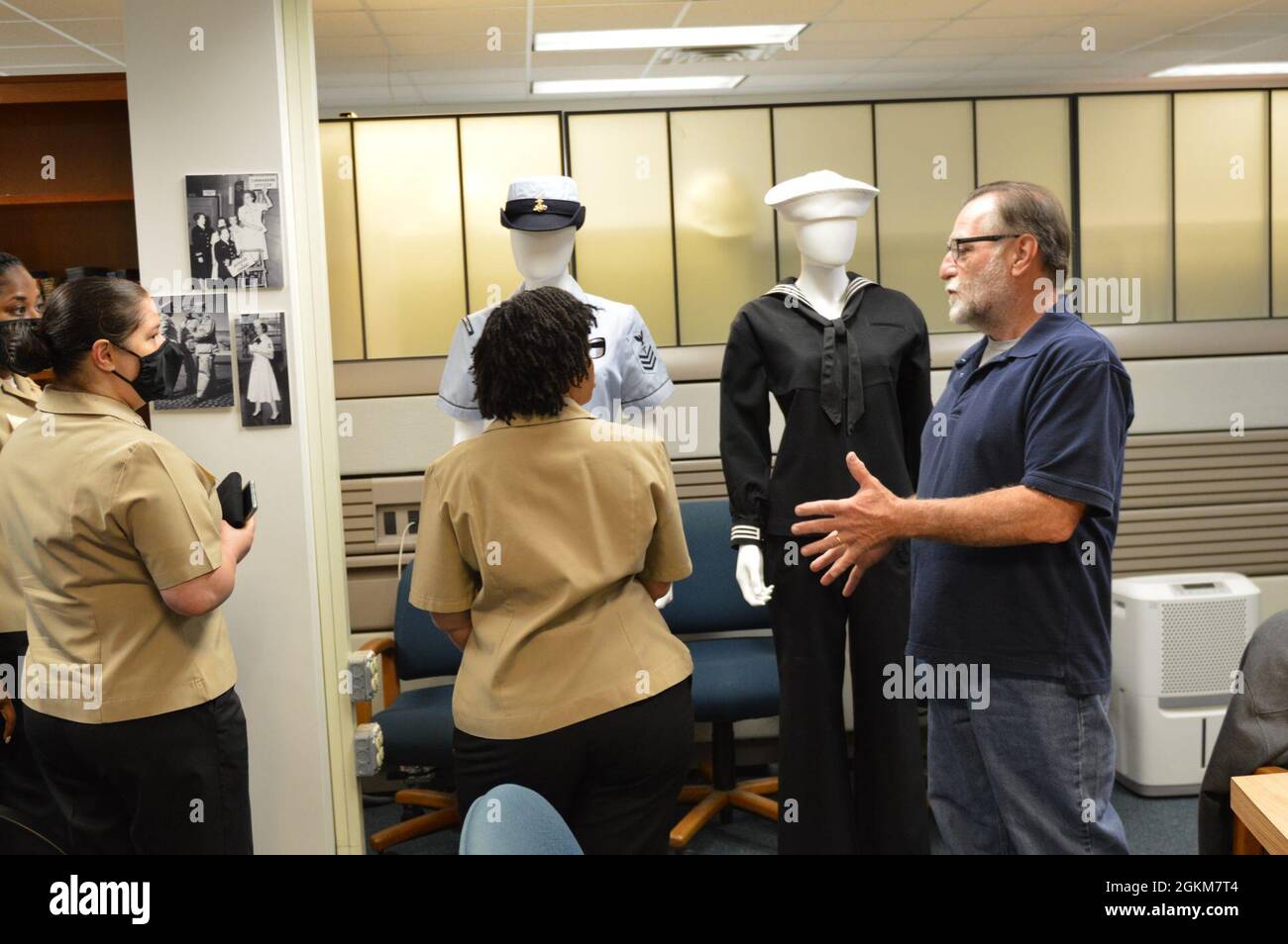 Jim Leuci, MCPO, USN (ausgeschieden), ein Volunteer am Hampton Roads Naval Museum, bietet einige der historischen Uniformen, die im Nebengebäude des Museums an Bord der Naval Station Norfolk ausgestellt sind, aussagekräftige Interpretationen. Die Tour durch den Anbau des Museums bot einige historische Verbindungen zur US-Marine im Hampton Roads-Gebiet für die Nominierten des Seemanns des Jahres. Stockfoto